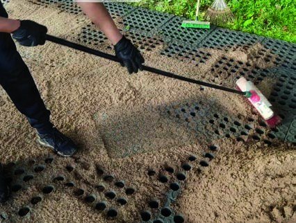Leveling the sand topping across an installed area